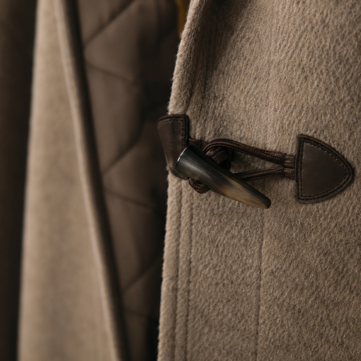 Greyfell hooded wool cape — Down & Cape Outerwear by MASO. close detail of the fabric and finish.