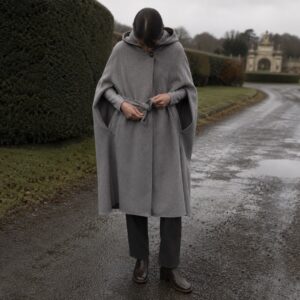 Bramwell hooded wool cape — Down & Cape Outerwear by MASO. worn by a model.