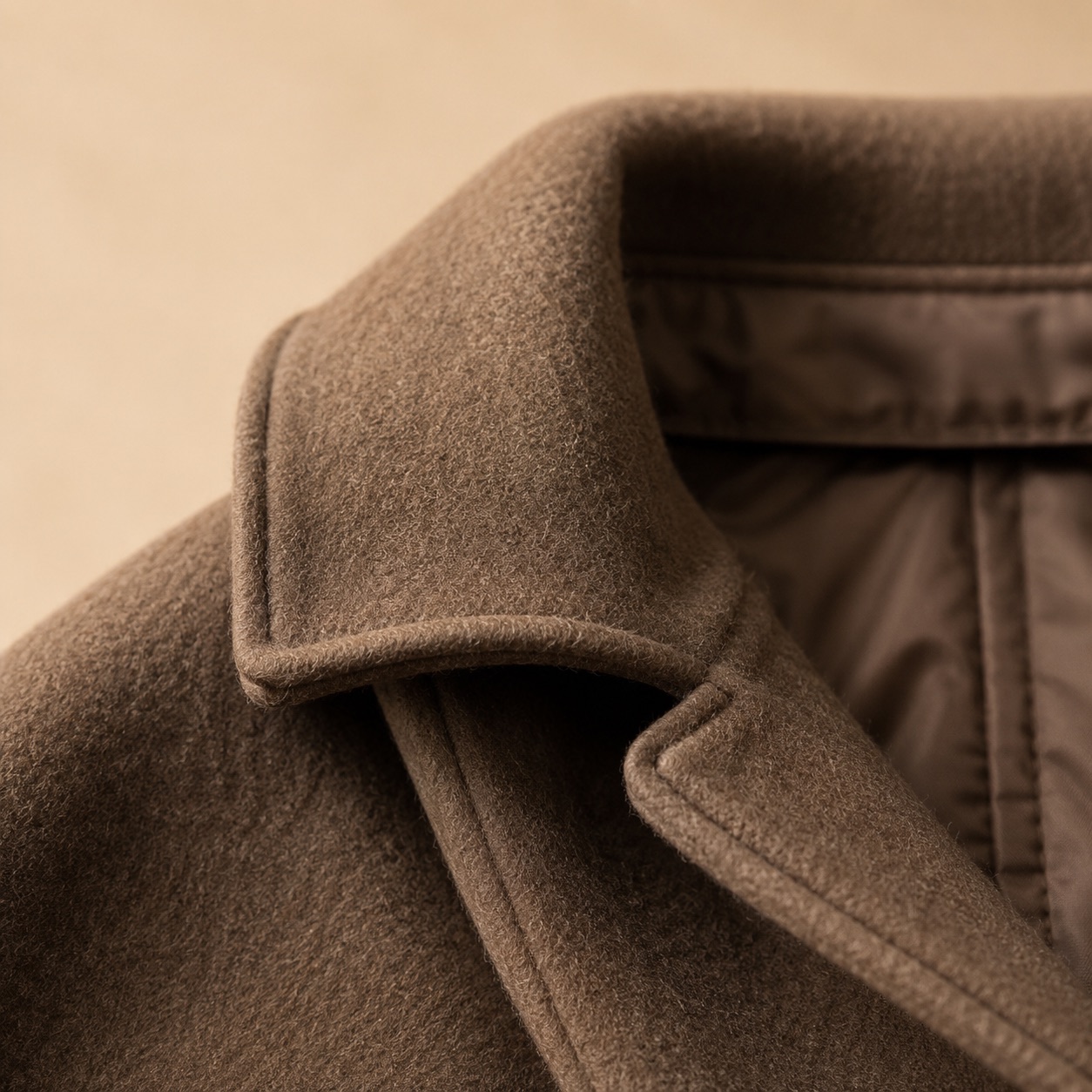 Cotswold wool cape with arm slits — Down & Cape Outerwear by MASO. close detail of the fabric and finish.