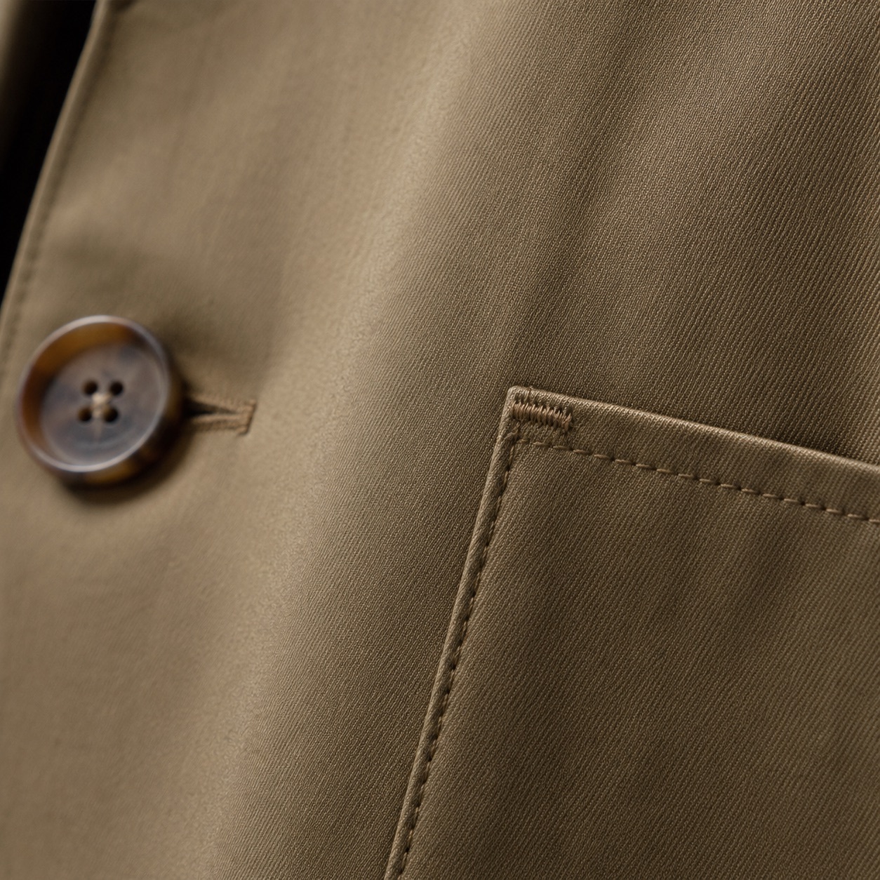 Wildersham short raglan trench — Trench Coats by MASO. close detail of the fabric and finish.