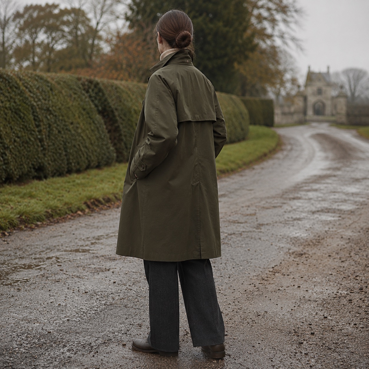Windrush short raglan trench — Trench Coats by MASO. worn by a model, side view.