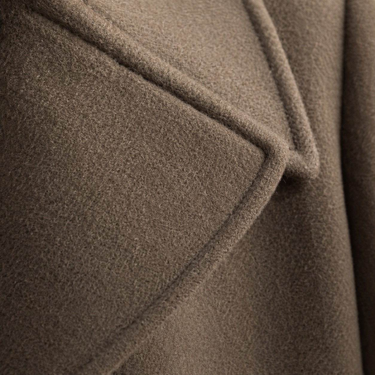 Blackthorn double-breasted long coat — Wool Long Coats by MASO. close detail of the fabric and finish.