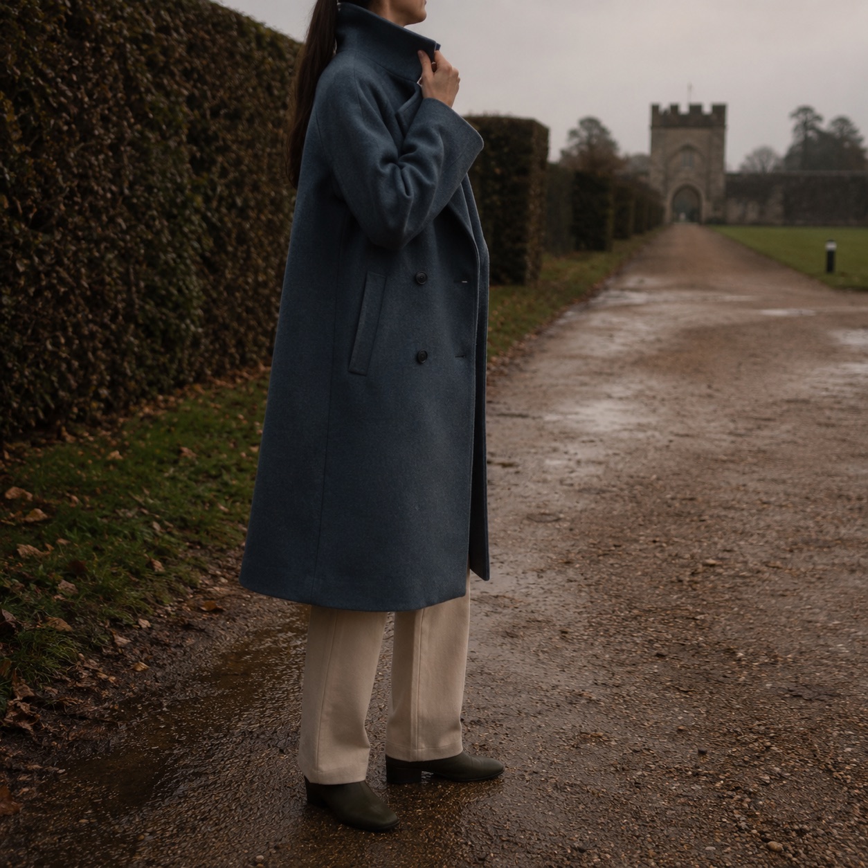Stonebridge double-breasted long coat — Wool Long Coats by MASO. worn by a model, side view.